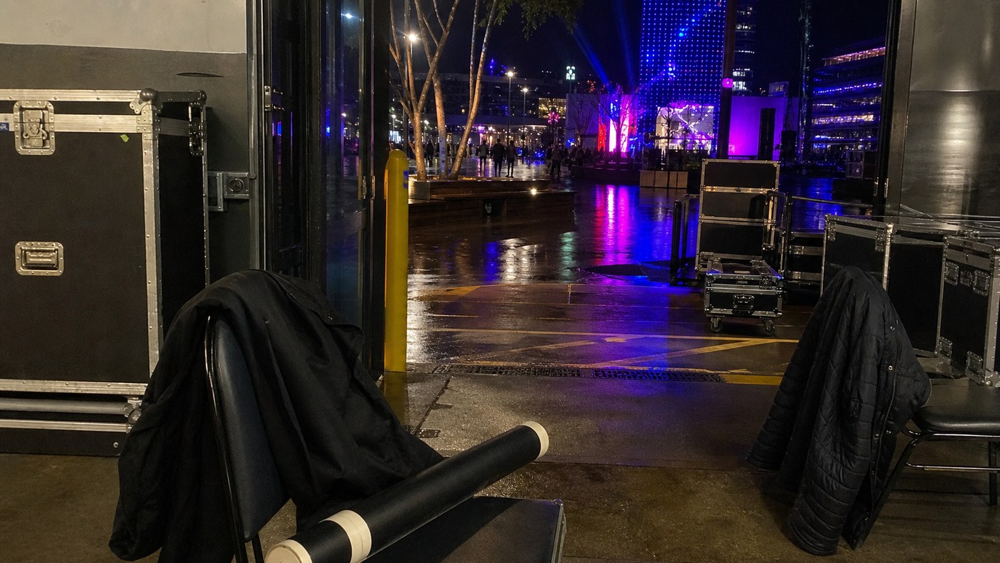 Night-time event logistics near a wet Sydney venue loading area