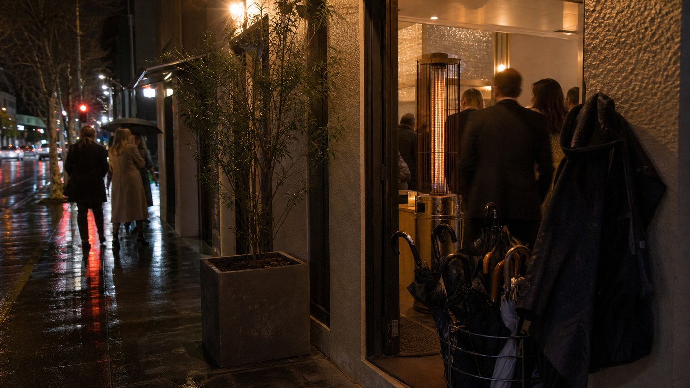 Cold wet Sydney venue entrance with coats and umbrellas at night